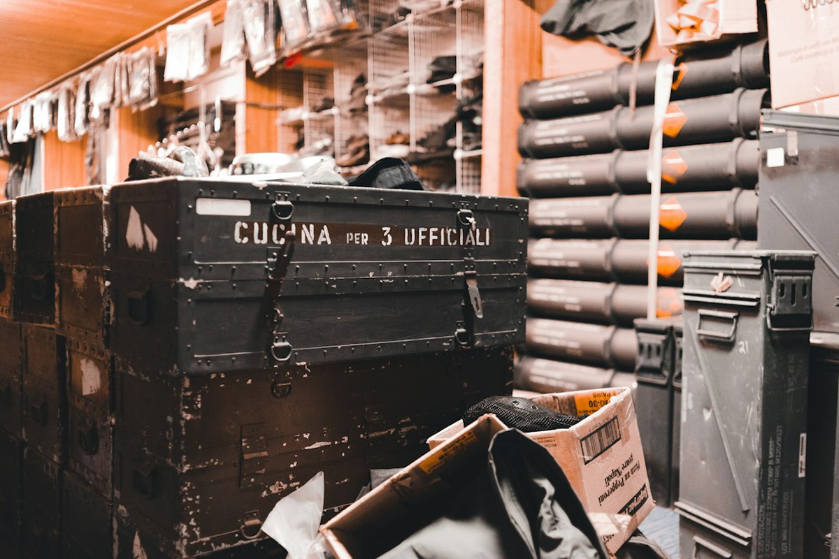 Event equipment cases and dressed table components stacked in a working prep room
