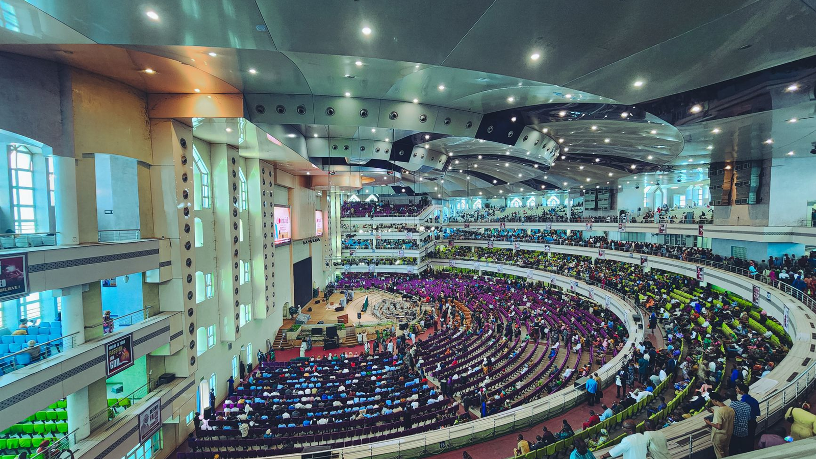 Wide view of a busy casino-themed event evening with adult guests gathered around several hosted tables