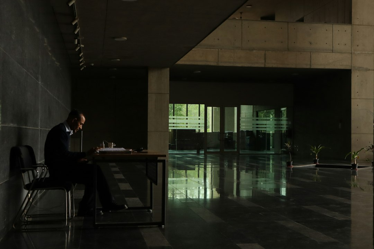 Planning desk with a venue floor plan, notebook and sample unmarked event chips under warm light