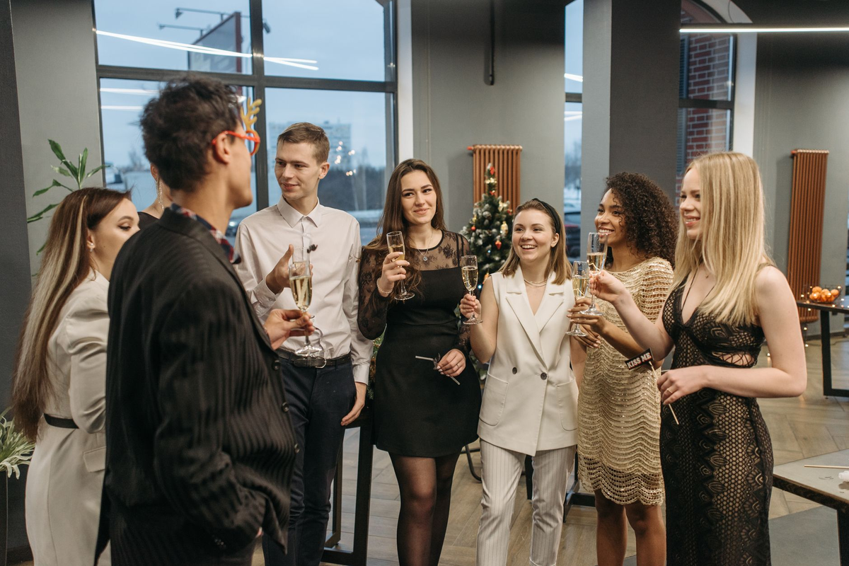 Formally dressed adult guests gathered around a hosted event table at a corporate evening reception