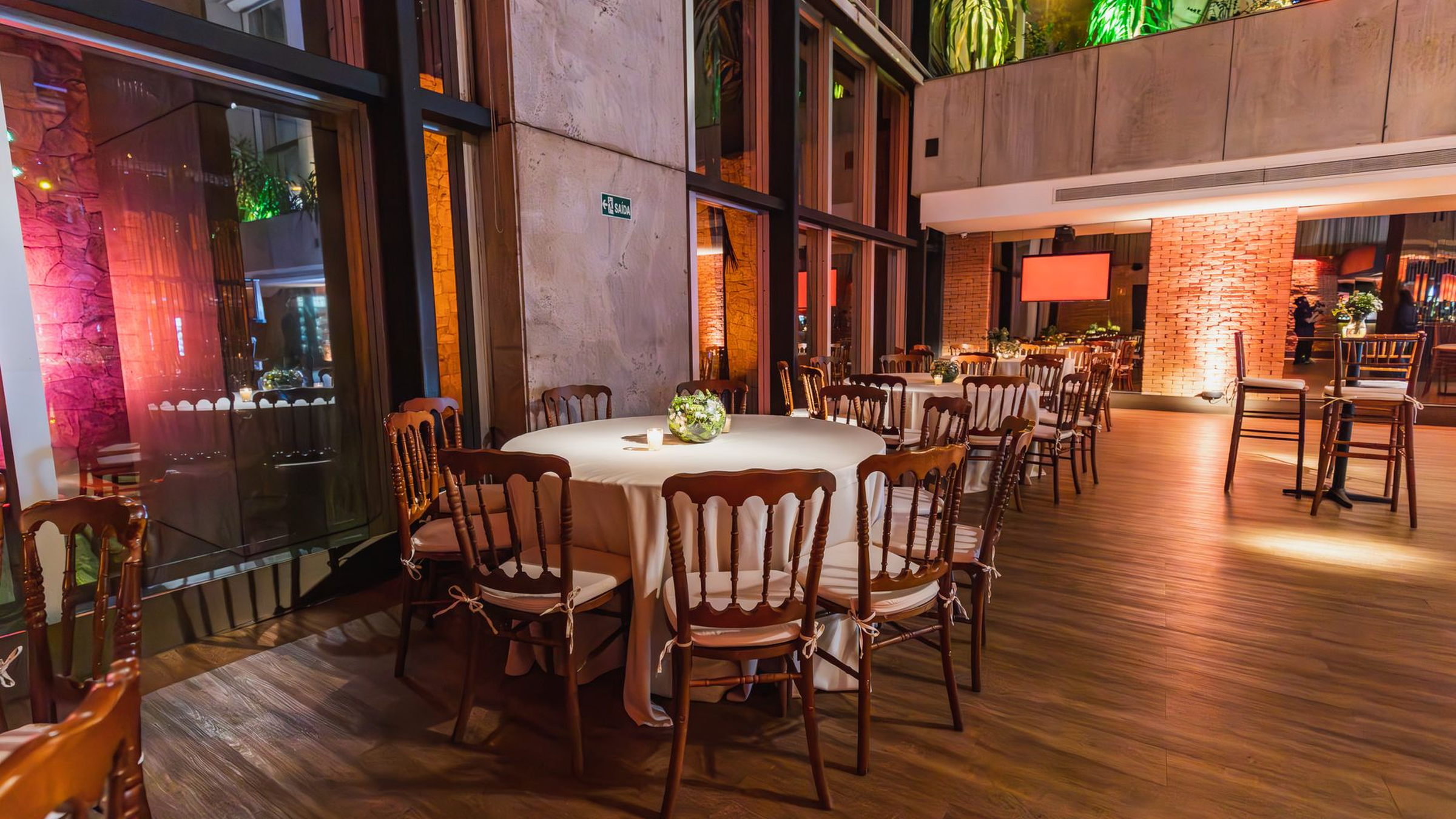 Adult guests in formal dress around softly lit event tables at a casino-themed evening