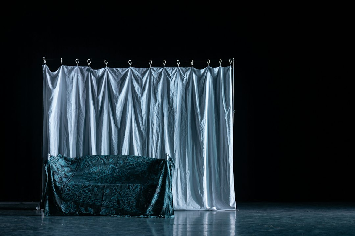 Styled photo zone with draped backdrop and discreet lighting at an adult event