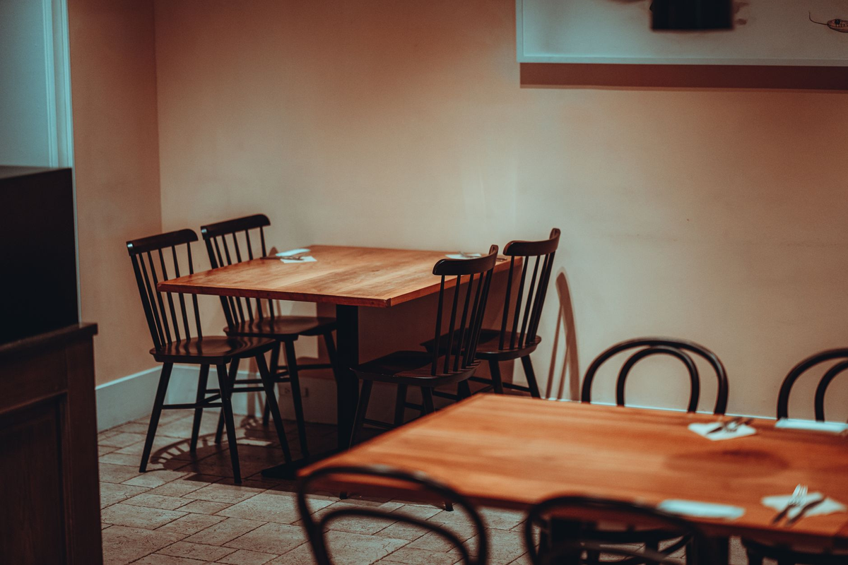 Intimate reserved event table in a softly lit VIP lounge set for adult guests